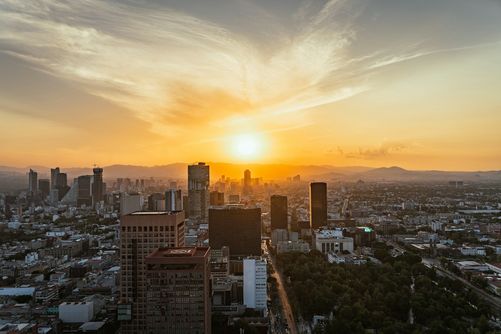 Aerial view of Mexico City with buildings and mountains in the background